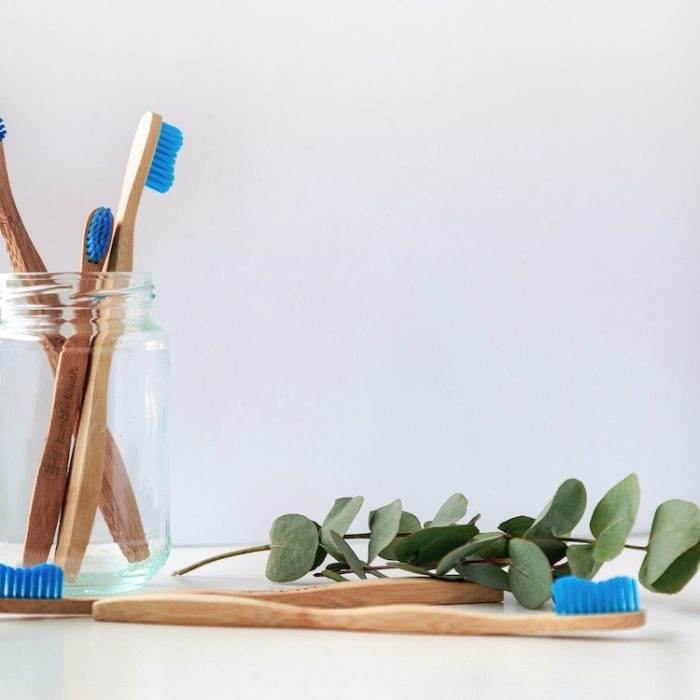 Four toothbrushes in a glas
