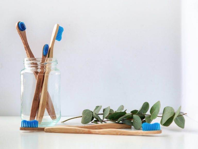 Four toothbrushes in a glas