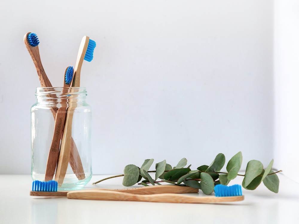 Four toothbrushes in a glas